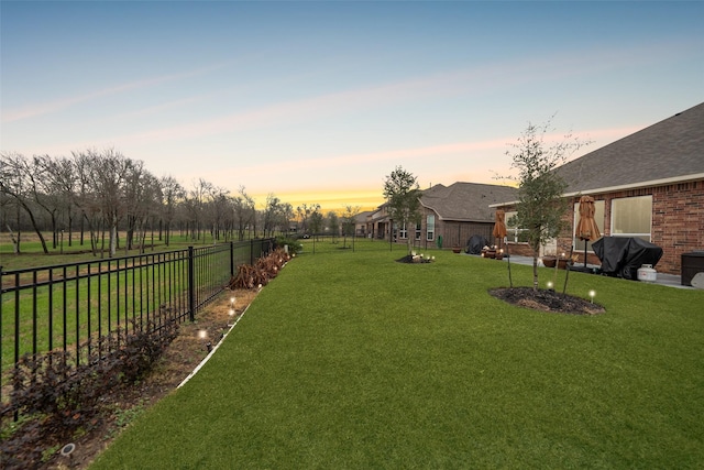 view of yard at dusk