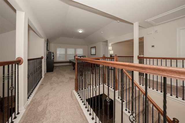 hallway featuring light carpet and vaulted ceiling