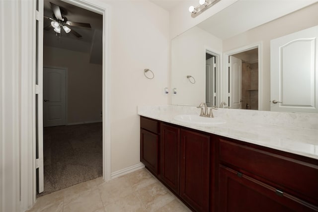 bathroom with ceiling fan, vanity, and a shower