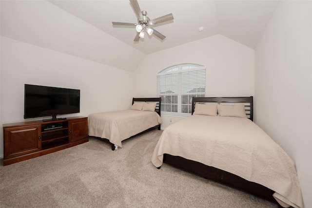 bedroom featuring ceiling fan, vaulted ceiling, and light carpet