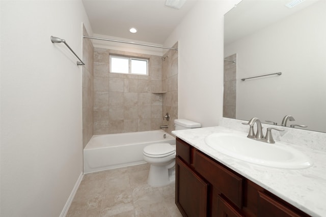 full bathroom with tiled shower / bath, vanity, and toilet