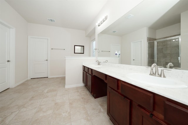 bathroom with vanity and a shower with shower door