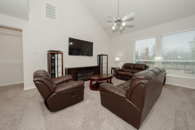 living room with ceiling fan, light colored carpet, high vaulted ceiling, and a wealth of natural light