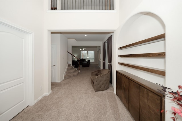 foyer entrance with light colored carpet