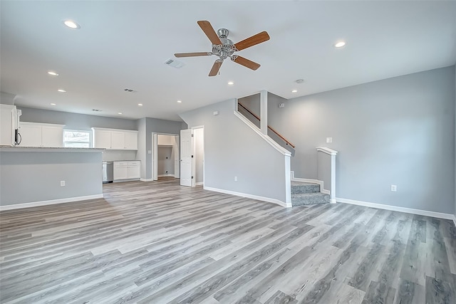 unfurnished living room featuring ceiling fan and light wood-type flooring