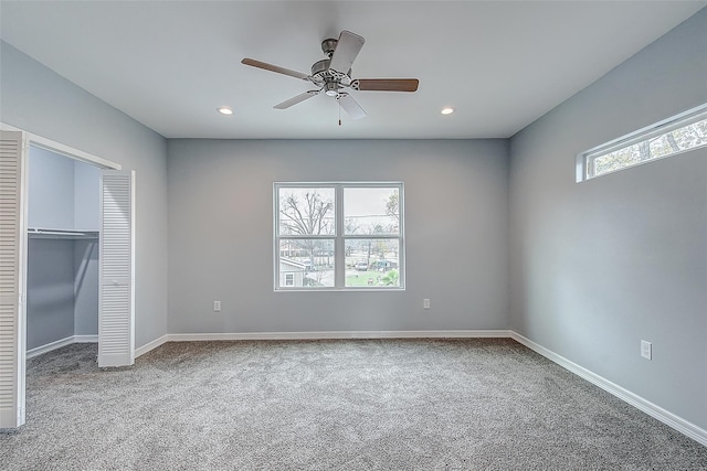 unfurnished bedroom with ceiling fan, carpet flooring, and a closet