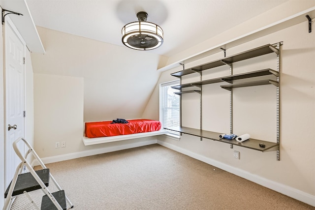 unfurnished bedroom with baseboards, lofted ceiling, and carpet