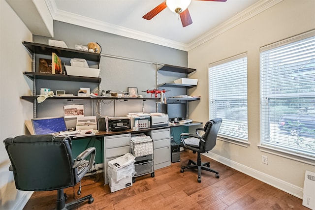 office area featuring baseboards, a ceiling fan, light wood-style floors, and ornamental molding