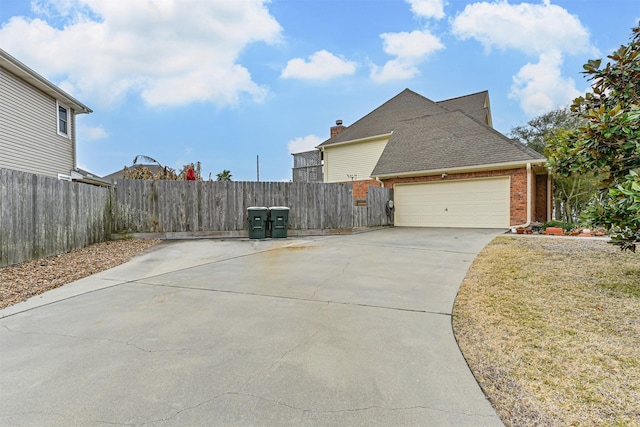 view of property exterior with brick siding, roof with shingles, driveway, and fence