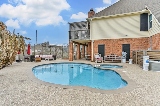 view of swimming pool with a fenced in pool, fence, an outdoor hangout area, a patio area, and an in ground hot tub