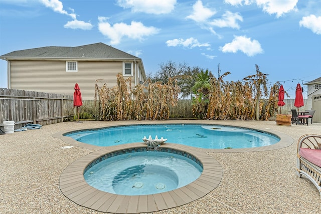 view of pool featuring an in ground hot tub, a fenced in pool, a patio area, and fence