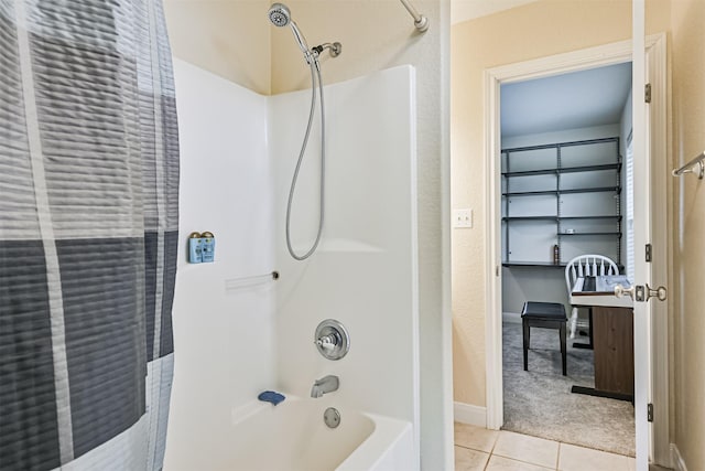 bathroom with tile patterned floors, baseboards, and bathtub / shower combination