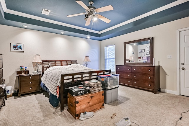 bedroom with a raised ceiling, carpet flooring, crown molding, and visible vents