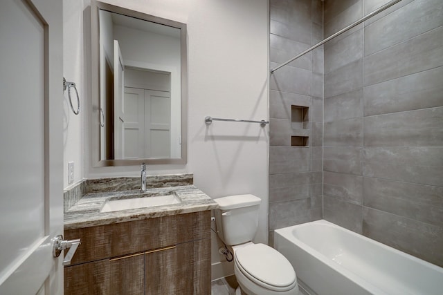 full bathroom with tiled shower / bath, vanity, and toilet