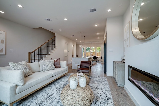 living room featuring sink and light hardwood / wood-style floors