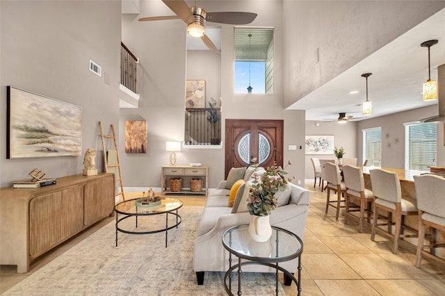 living room featuring ceiling fan, a healthy amount of sunlight, and light tile patterned floors