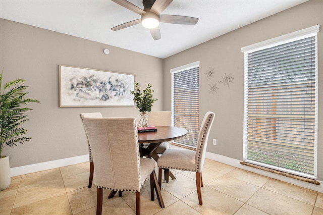 tiled dining space with ceiling fan