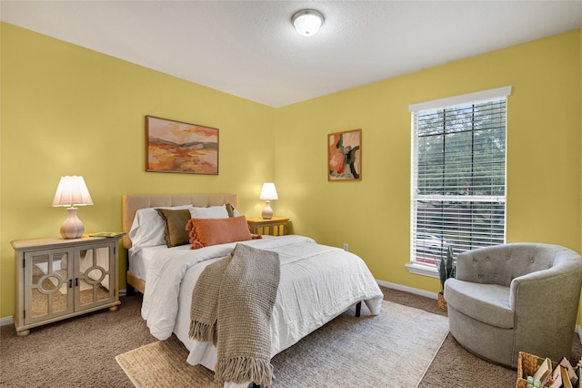 carpeted bedroom featuring a textured ceiling