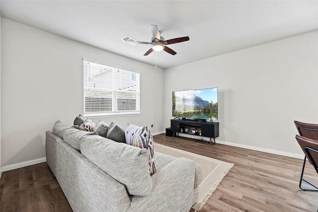 living room with hardwood / wood-style floors and ceiling fan