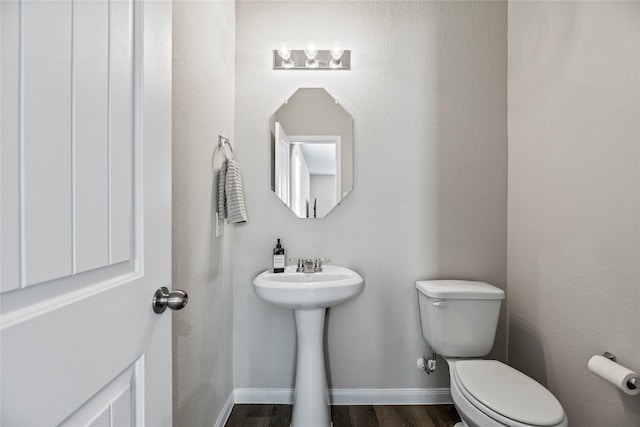 bathroom with wood-type flooring and toilet