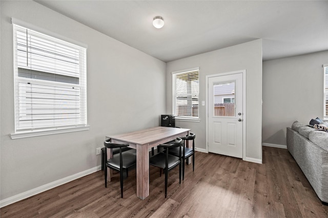 dining area with dark hardwood / wood-style floors