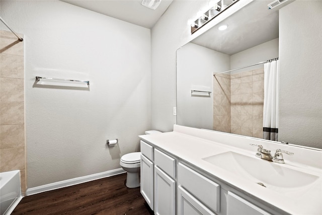 full bathroom with vanity, wood-type flooring, shower / tub combo, and toilet