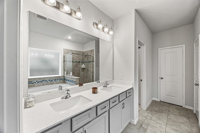 bathroom with tile patterned flooring, vanity, and separate shower and tub