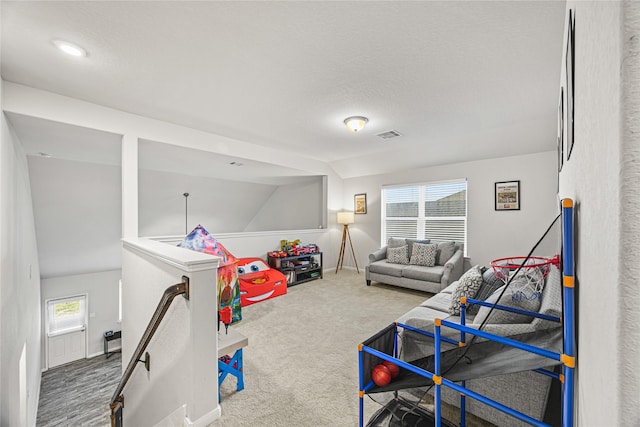 playroom with lofted ceiling, plenty of natural light, and carpet flooring