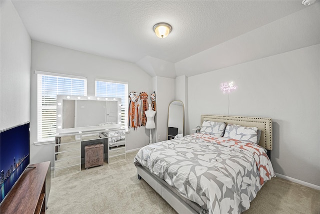 bedroom with light carpet, vaulted ceiling, and a textured ceiling