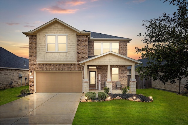 view of front of home featuring a garage and a lawn