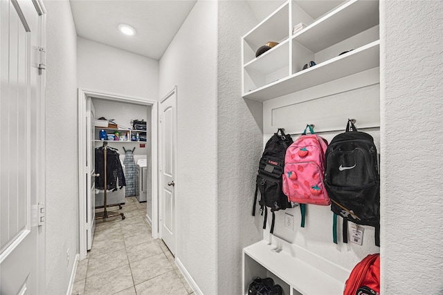 mudroom featuring light tile patterned flooring and washer / dryer