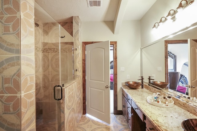 bathroom with walk in shower, tile patterned floors, and vanity