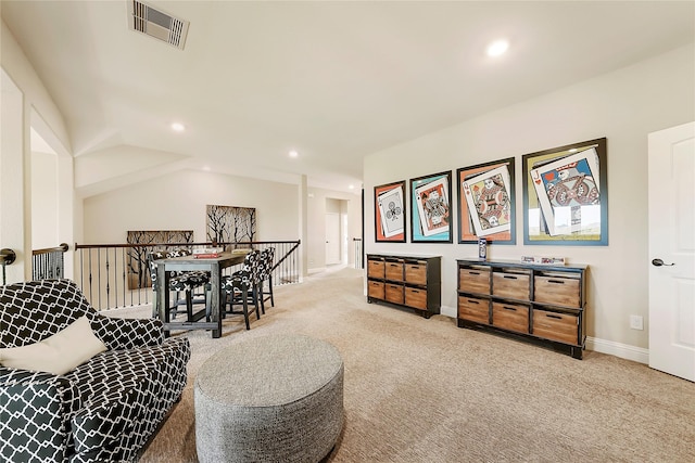 sitting room featuring light carpet and vaulted ceiling