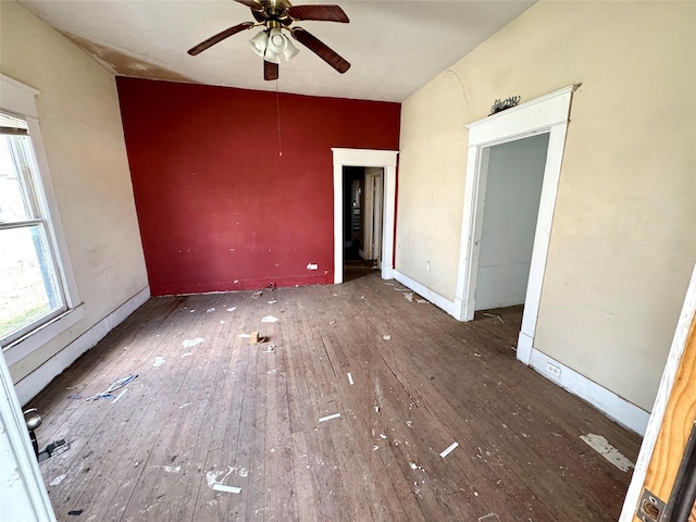 interior space with dark wood-type flooring and ceiling fan