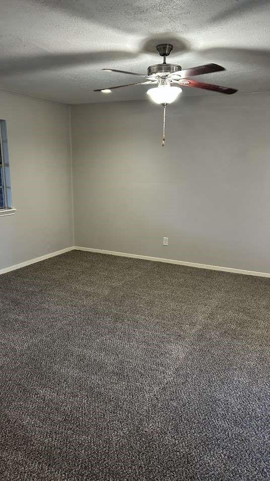 1809 Paloma Ave, Richmond, TX 77469 - empty room featuring ceiling fan, carpet, and a textured ceiling