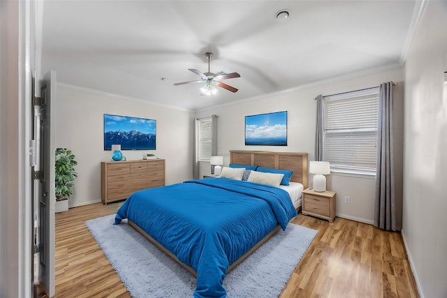 bedroom with light wood-type flooring, ornamental molding, and ceiling fan