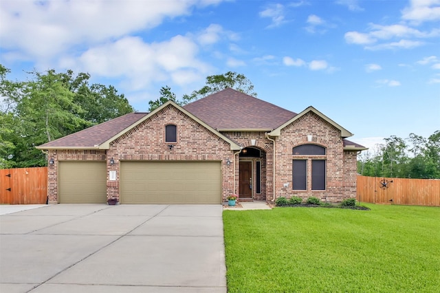 view of front of property featuring a garage and a front yard