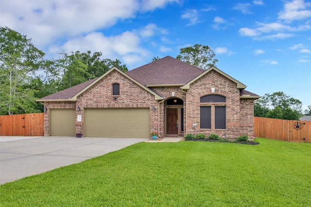 view of front of house with a garage and a front lawn