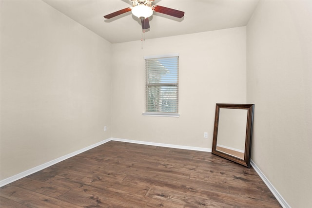 spare room featuring dark wood-type flooring and ceiling fan