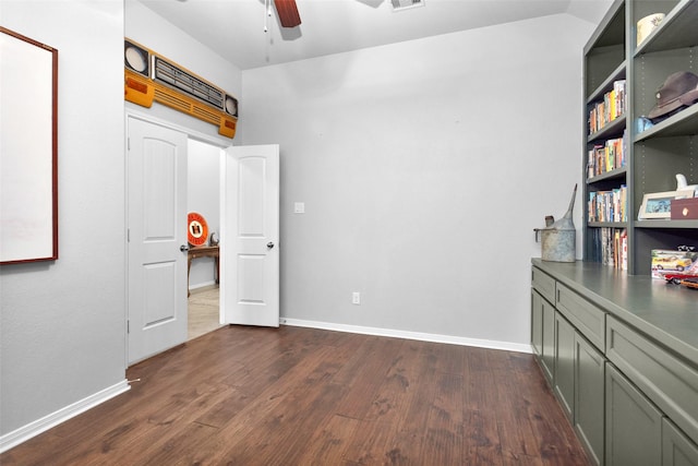 unfurnished bedroom with dark hardwood / wood-style flooring, vaulted ceiling, and ceiling fan