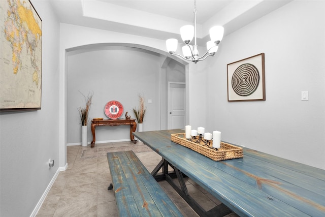 dining area with an inviting chandelier and light tile patterned floors