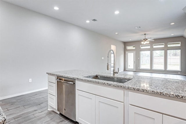 19723 Sandstone Bluff Way, Cypress, TX 77433 - kitchen with a sink, a ceiling fan, light wood finished floors, dishwasher, and visible vents