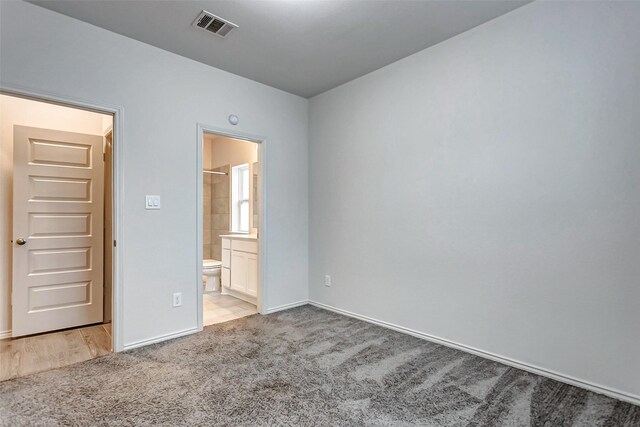 19723 Sandstone Bluff Way, Cypress, TX 77433 - unfurnished bedroom with ensuite bath, visible vents, baseboards, and carpet