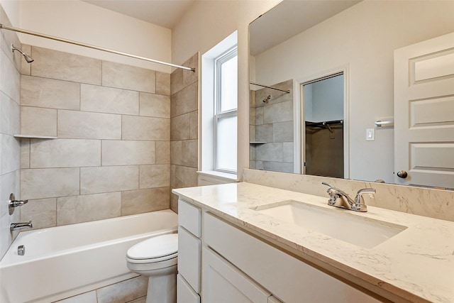 full bathroom with vanity, toilet, and tiled shower / bath combo