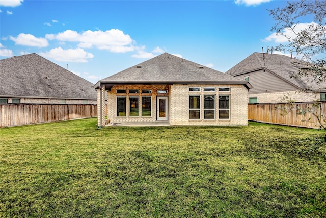 19723 Sandstone Bluff Way, Cypress, TX 77433 - rear view of house with a fenced backyard, a patio area, brick siding, and a yard