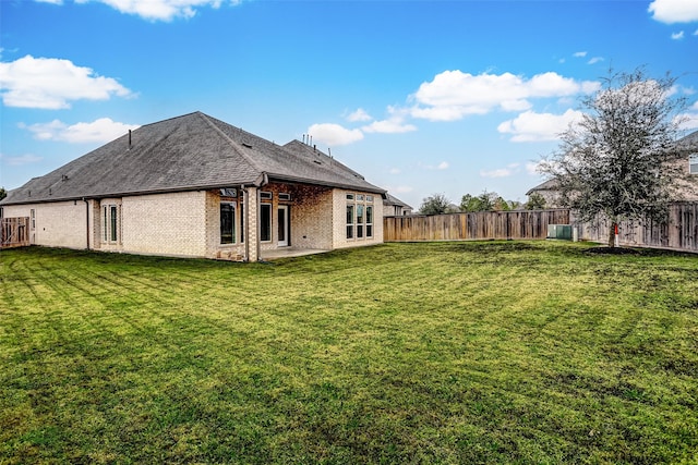 19723 Sandstone Bluff Way, Cypress, TX 77433 - rear view of house featuring brick siding, a fenced backyard, a yard, and a patio area