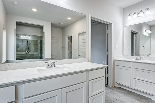 19723 Sandstone Bluff Way, Cypress, TX 77433 - bathroom with a stall shower, visible vents, a sink, and two vanities