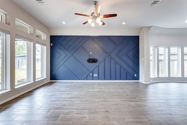 spare room with light hardwood / wood-style flooring and ceiling fan