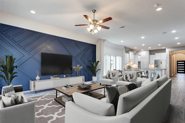 19723 Sandstone Bluff Way, Cypress, TX 77433 - living area with light wood-type flooring, recessed lighting, an accent wall, visible vents, and ceiling fan