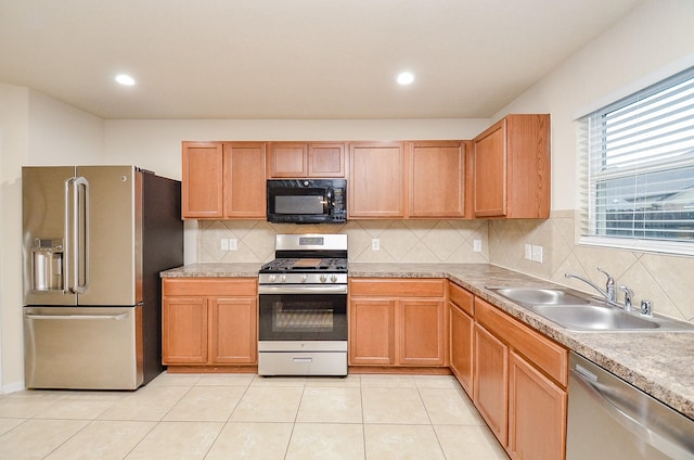 kitchen with sink, backsplash, stainless steel appliances, and light tile patterned flooring